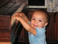 Max playing piano at the beach house in Bay Head