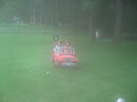 August 2006 Photos: Skye taking Alex for a ride in her jeep. (humid day, lens fog!)