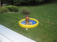 August 2006 Photos: Alex swimming with all his clothes on in the baby pool.