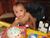 Max's first birthday: Max with his cake.