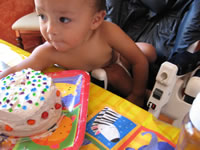 Max's first birthday: Max with his cake.