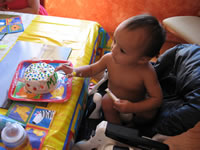 Max's first birthday: Max with his cake.