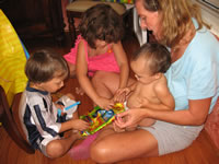 Max's first birthday: Opening presents with Mom, Alex and Carissa.