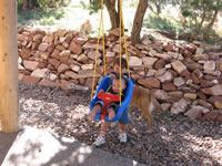 September 2006 Photos: Alex giving Max a ride on the swing on our back porch.