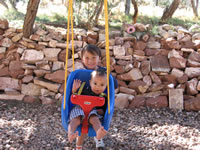 September 2006 Photos: Alex giving Max a ride on the swing on our back porch.