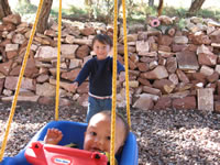 September 2006 Photos: Alex giving Max a ride on the swing on our back porch.