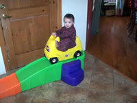 December 2006: Max on the rollercoaster that Santa brought (their favorite!)