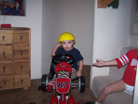 January 2007: Max with hard hat in the pedal car.