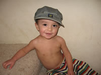 January 2007: Max likes hats, especially his train conductor's cap!