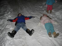 January 2007: Alex and Ashlyn making snow angels in our driveway.