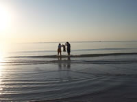 February 2007: Chris and Nana helping Alex jump over the waves.