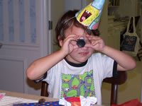 March 2007: Alex with a little spying scope he got as a present.