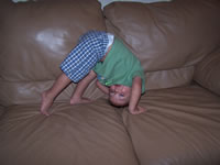 March 2007: Max doing flips on the couch.