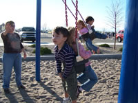 March 2007: Alex and Ashlyn, Max and Peyton sharing rides in the bucket swings.