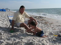 March 2007: Chris would make a one-bucket sand castle and Max would smoosh it the second Chris took the bucket away. This went on for about twenty minutes, I think. 