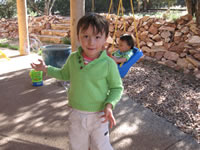 April 2007: Alex playing with bubbles on the porch (Grandmama knitted his awesome sweater!)