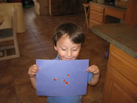 May 2007: Alex with a sticker picture he made.