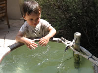 August 2007: Max playing in one of the fountains in Uncle Brad and Aunt Leslie's garden in Santa Fe.