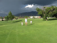 August 2007: Family golf at Los Altos in Albuquerque. The storm behind us didn't come our way, but it was cool to watch it move along the mountains.