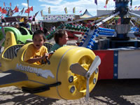 Sept 2007: Logan and Alex had a blast at the fair. They loved going on rides together, especially this one in an airplane that went up and down.