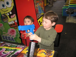 January 2008: Alex playing a video game with a gun. Yikes! 