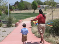 April 2008: Chris and Alex going to fly a kite at Ashlyn and Peyton's kite-themed birthday party. It was a perfect day for it! At one point there were about 20 kites up in the air, a lovely and festive sight on a beautiful Spring day in Albuquerque.