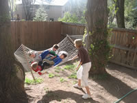 May 2008: Laurie swinging all the boys on her hammock.