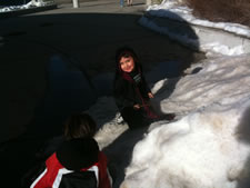 February 2010: Max in his Hogwarts robe playiing on snow bank