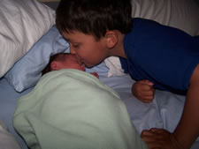 July 2010: Max kissing his new brother