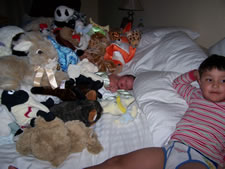 July 2010: Max and Alex brought loads of stuffed animals to surround their new brother