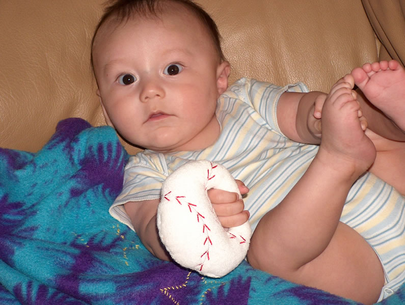 Alex and his baseball rattle.