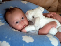 Cuddling with the lamb from Aunt Tanya. (77kb)