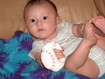 Alex and his baseball rattle. (97kb)