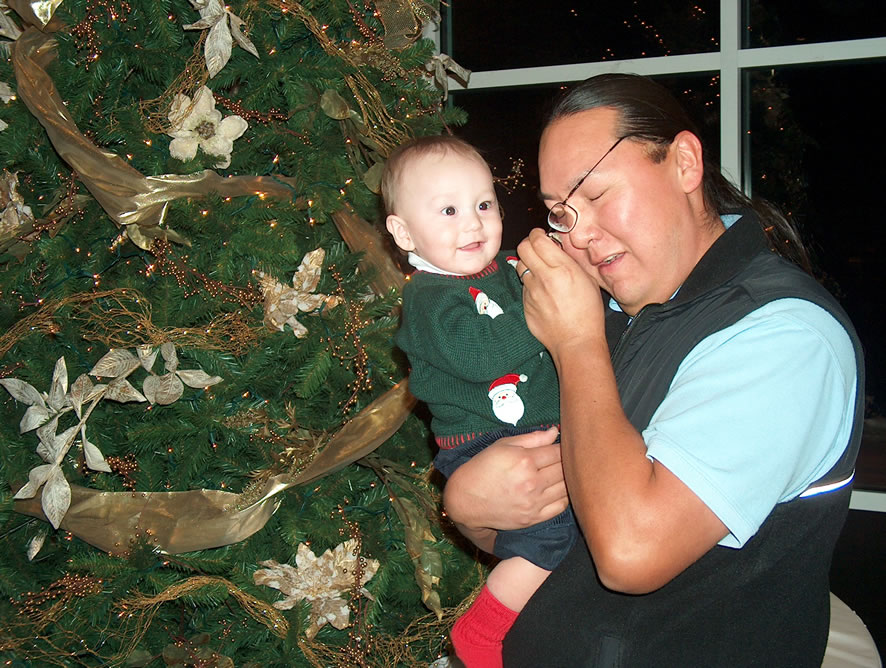 Removing Dad's glasses at a holiday party at Four Hills