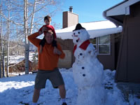 November 2007: Chris DeMerrit and Max next to the HUGE snowman he (Chris) built while we were in Durango for Thanksgiving.