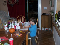 November 2007: Alex drawing. You can see the little snowmen we all made lined up on the table. (Grandmama is so clever!)